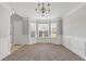 Formal dining room with classic wainscoting, chandelier, and bay window at 1116 Oak Hollow Ln, Hampton, GA 30228