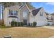 Charming two-story home featuring stone accents, a well-maintained lawn, and attached two-car garage at 1116 Oak Hollow Ln, Hampton, GA 30228