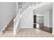 Inviting foyer with staircase, neutral tile flooring, and views into the home's living spaces at 1116 Oak Hollow Ln, Hampton, GA 30228