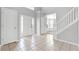 Bright and airy foyer with tile flooring, staircase, coat closet and plentiful natural light at 1116 Oak Hollow Ln, Hampton, GA 30228