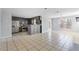Open-concept kitchen with tile flooring, gray cabinetry, stainless appliances, seamlessly connecting to living spaces at 1116 Oak Hollow Ln, Hampton, GA 30228