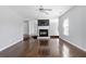 Bright living room featuring a fireplace, hardwood floors, and neutral paint for versatile styling at 1116 Oak Hollow Ln, Hampton, GA 30228