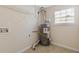 Utility room featuring linoleum flooring and an older hot water heater at 1116 Oak Hollow Ln, Hampton, GA 30228