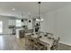 Bright open dining area with modern light fixtures adjacent to a gourmet kitchen, great for entertaining at 1238 Ainsworth Aly # 38, Sugar Hill, GA 30518