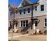Charming townhome featuring brick facade, gray siding, and well-maintained landscaping at 1238 Ainsworth Aly # 38, Sugar Hill, GA 30518