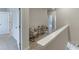 Upstairs hallway with two chairs, and two entryways to bedrooms at 1238 Ainsworth Aly # 38, Sugar Hill, GA 30518