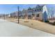 Row of newly built townhouses showcasing modern exteriors and well-manicured front yards at 1238 Ainsworth Aly # 38, Sugar Hill, GA 30518