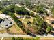 Aerial view of a wooded property with surrounding homes, landscaping, and nearby parking lot at 1505 Ozora Rd, Loganville, GA 30052