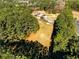 Aerial view of a wooded property featuring a detached garage and mature trees at 1505 Ozora Rd, Loganville, GA 30052