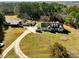 Aerial view of a spacious home on a sprawling lot, featuring mature trees and a long driveway at 1505 Ozora Rd, Loganville, GA 30052