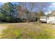 Expansive backyard features a large lawn, mature trees and a detached structure at 1505 Ozora Rd, Loganville, GA 30052