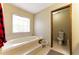 Relaxing bathroom with a soaking tub and separate toilet at 1505 Ozora Rd, Loganville, GA 30052