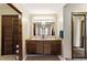 Bathroom featuring double sinks, wood cabinets, and great lighting at 1505 Ozora Rd, Loganville, GA 30052