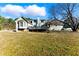 Exterior view of the rear of home with a wooden deck and backyard at 1505 Ozora Rd, Loganville, GA 30052