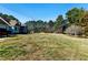 Large grassy front yard leading up to a charming home at 1505 Ozora Rd, Loganville, GA 30052