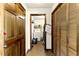 Hallway view with wood doors and access to laundry area at 1505 Ozora Rd, Loganville, GA 30052