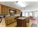 Spacious kitchen featuring wood cabinets, island cooktop, and an adjacent dining area at 1505 Ozora Rd, Loganville, GA 30052