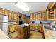 Spacious kitchen featuring wooden cabinetry and tile countertops at 1505 Ozora Rd, Loganville, GA 30052
