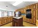 Charming kitchen with wood cabinets, cooktop island, and stainless steel refrigerator at 1505 Ozora Rd, Loganville, GA 30052