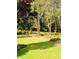 Beautiful backyard with a plush lawn and mature landscape design at 3585 Shepherds Ln, Loganville, GA 30052
