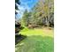 Lush green backyard with mature trees and landscape design at 3585 Shepherds Ln, Loganville, GA 30052