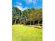 Expansive green backyard with mature trees offers a serene outdoor retreat at 3585 Shepherds Ln, Loganville, GA 30052