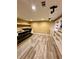 Finished basement with wood-look floors, built-in shelving, and countertop area at 3585 Shepherds Ln, Loganville, GA 30052