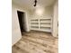 Versatile bonus room with built-in shelving and modern flooring, perfect for any use at 3585 Shepherds Ln, Loganville, GA 30052