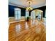 Dining area showcasing hardwood floors, chair rail, and a modern chandelier, perfect for entertaining at 3585 Shepherds Ln, Loganville, GA 30052