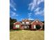 Charming brick home with manicured lawn, red front door, and classic architectural details at 3585 Shepherds Ln, Loganville, GA 30052