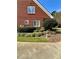 Brick home exterior with manicured landscaping and a sidewalk in the front yard at 3585 Shepherds Ln, Loganville, GA 30052
