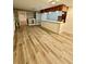 Open room with luxury vinyl plank flooring, a bar, and ample lighting at 3585 Shepherds Ln, Loganville, GA 30052