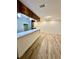 Open room with luxury vinyl plank flooring, a bar, and ample lighting at 3585 Shepherds Ln, Loganville, GA 30052