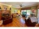 Comfortable living room features a fireplace, hardwood floors, and lots of natural light at 3585 Shepherds Ln, Loganville, GA 30052