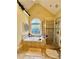 Bright primary bathroom with soaking tub, tiled shower, and stained glass window at 3585 Shepherds Ln, Loganville, GA 30052