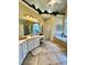 Bright primary bathroom with dual vanities, tile flooring, and a makeup table at 3585 Shepherds Ln, Loganville, GA 30052