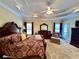 Spacious primary bedroom featuring tray ceilings, a ceiling fan, and large windows at 3585 Shepherds Ln, Loganville, GA 30052