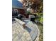 Backyard patio with outdoor cooking area and brick retaining wall at 3585 Shepherds Ln, Loganville, GA 30052