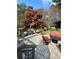 Covered patio with outdoor seating and lush landscaping provides a perfect entertaining area at 3585 Shepherds Ln, Loganville, GA 30052