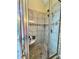 Tiled shower with glass door, dual showerheads, and built-in shelving at 3585 Shepherds Ln, Loganville, GA 30052