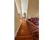 Well-lit staircase with wooden steps and decorative iron railing at 3585 Shepherds Ln, Loganville, GA 30052