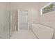 Luxurious bathroom featuring a soaking tub, walk-in shower, and marble tile at 723 Crest Line W Trl, Powder Springs, GA 30127