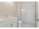 Modern bathroom featuring a walk-in shower with glass doors, a white vanity, and sleek fixtures at 723 Crest Line W Trl, Powder Springs, GA 30127