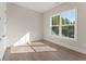 Sunlit bedroom with large windows, light hardwood flooring, and neutral wall paint at 723 Crest Line W Trl, Powder Springs, GA 30127