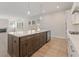 Open kitchen featuring a large island, modern appliances, and hardwood floors, with sight lines to the living room at 723 Crest Line W Trl, Powder Springs, GA 30127