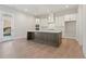 Open kitchen featuring a large center island, stainless steel appliances, and white cabinetry at 723 Crest Line W Trl, Powder Springs, GA 30127