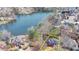 Aerial view of a brick house on a treed lot near a lake at 10815 Donamere Dr, Johns Creek, GA 30022