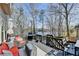 Outdoor deck featuring lake views, stylish seating, and a grill for entertaining at 10815 Donamere Dr, Johns Creek, GA 30022