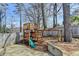 Fenced backyard featuring a wooden playset with slide and swing, perfect for Gathering fun at 10815 Donamere Dr, Johns Creek, GA 30022