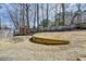 Large backyard featuring a playset, spacious grassy area, and a wooden fence for privacy at 10815 Donamere Dr, Johns Creek, GA 30022